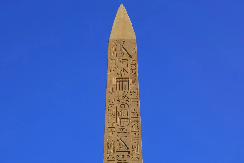 egyptian obelisk on a clear day with sky background