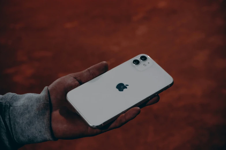 the white apple iphone in someones hand