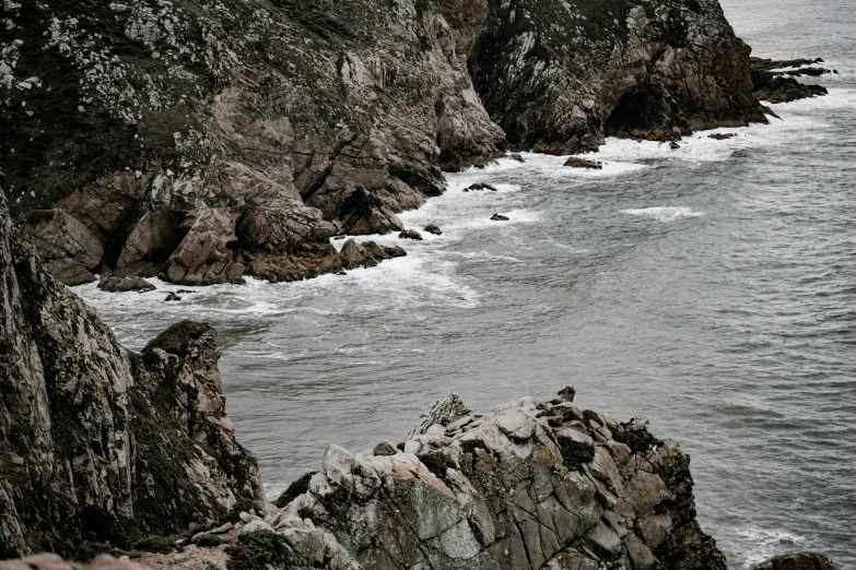 some very large rocks by the water and the ocean