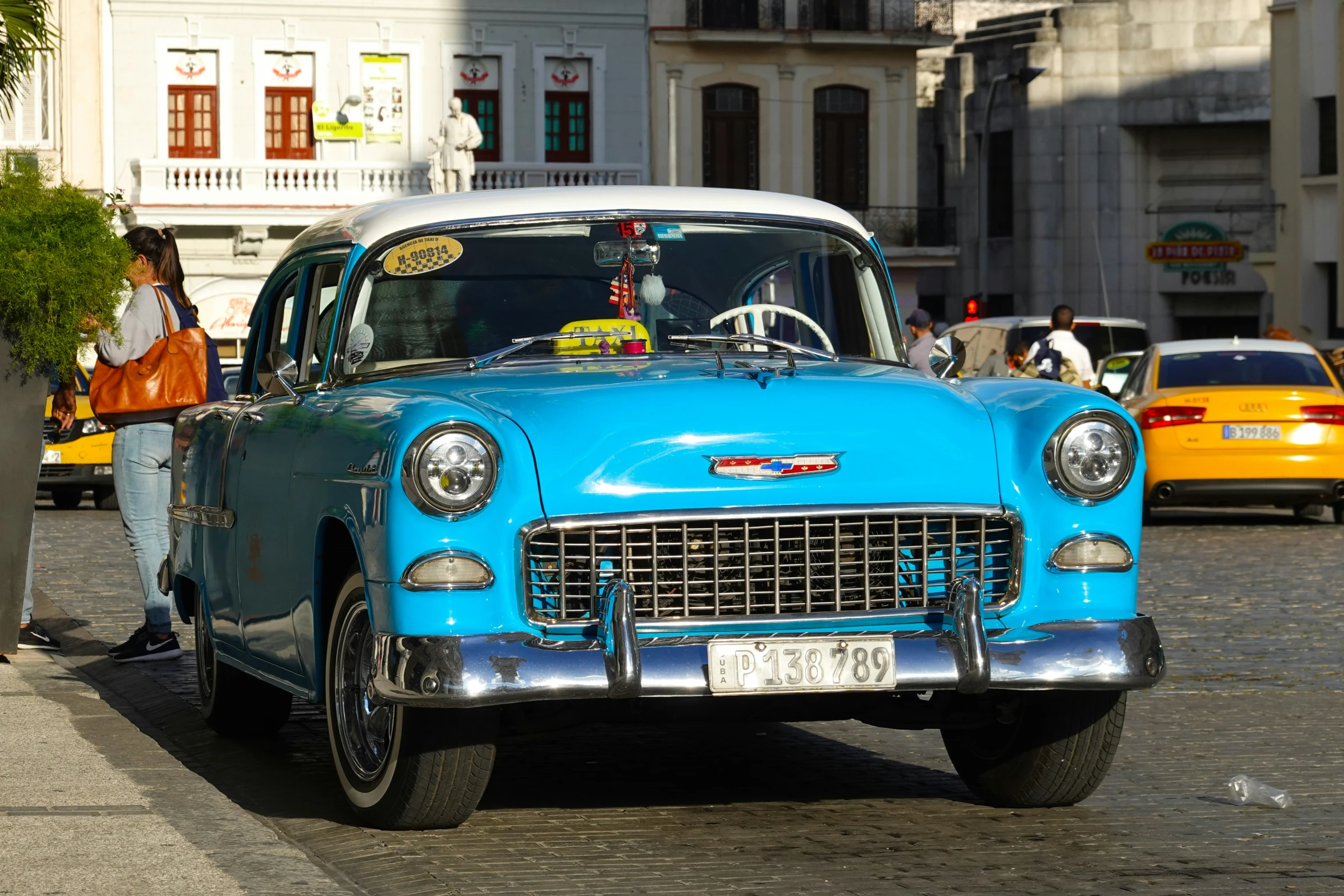 an old car parked in front of some other old cars