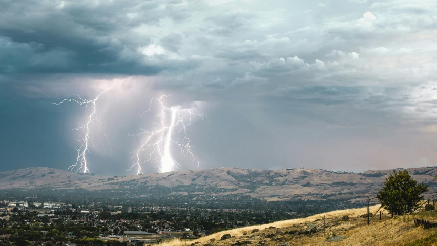 a large cluster of lightning strikes in the sky