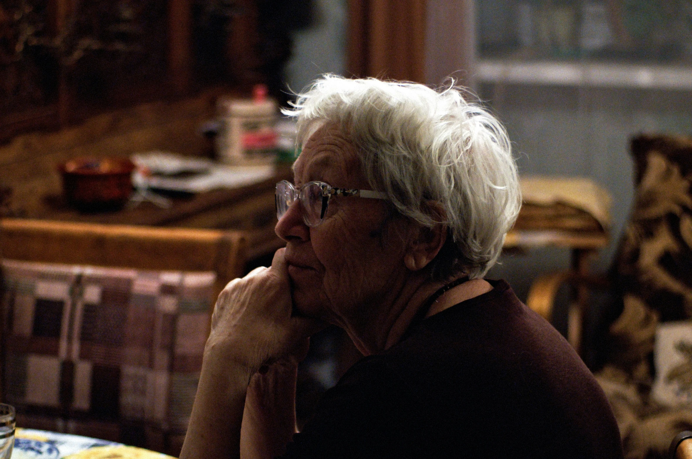 a woman sitting down with her chin resting against her chin