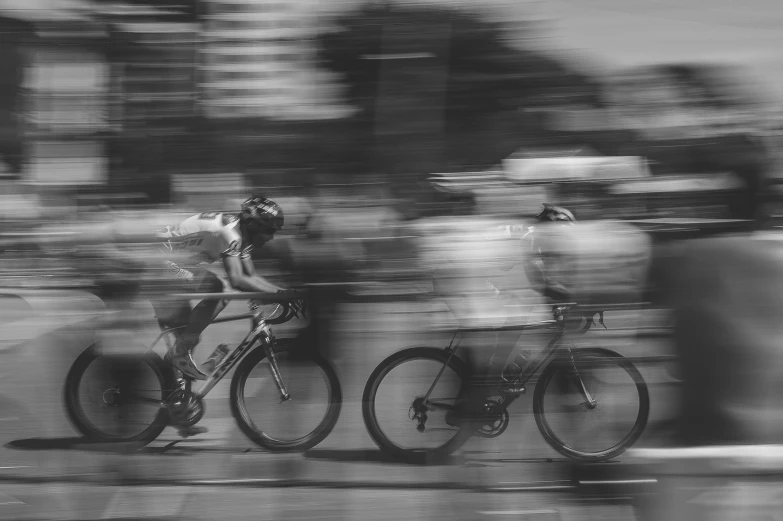 black and white pograph of two bicycle racers in motion