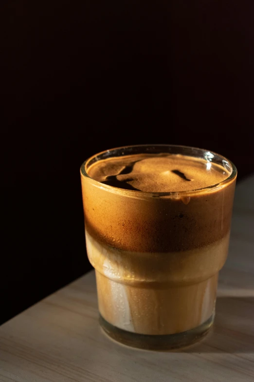 a brown and white cup is sitting on a table