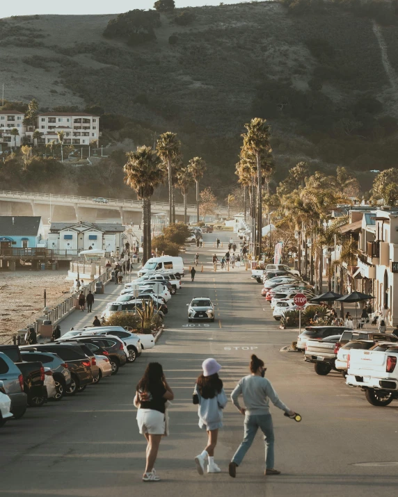 two women are walking in front of a parking lot