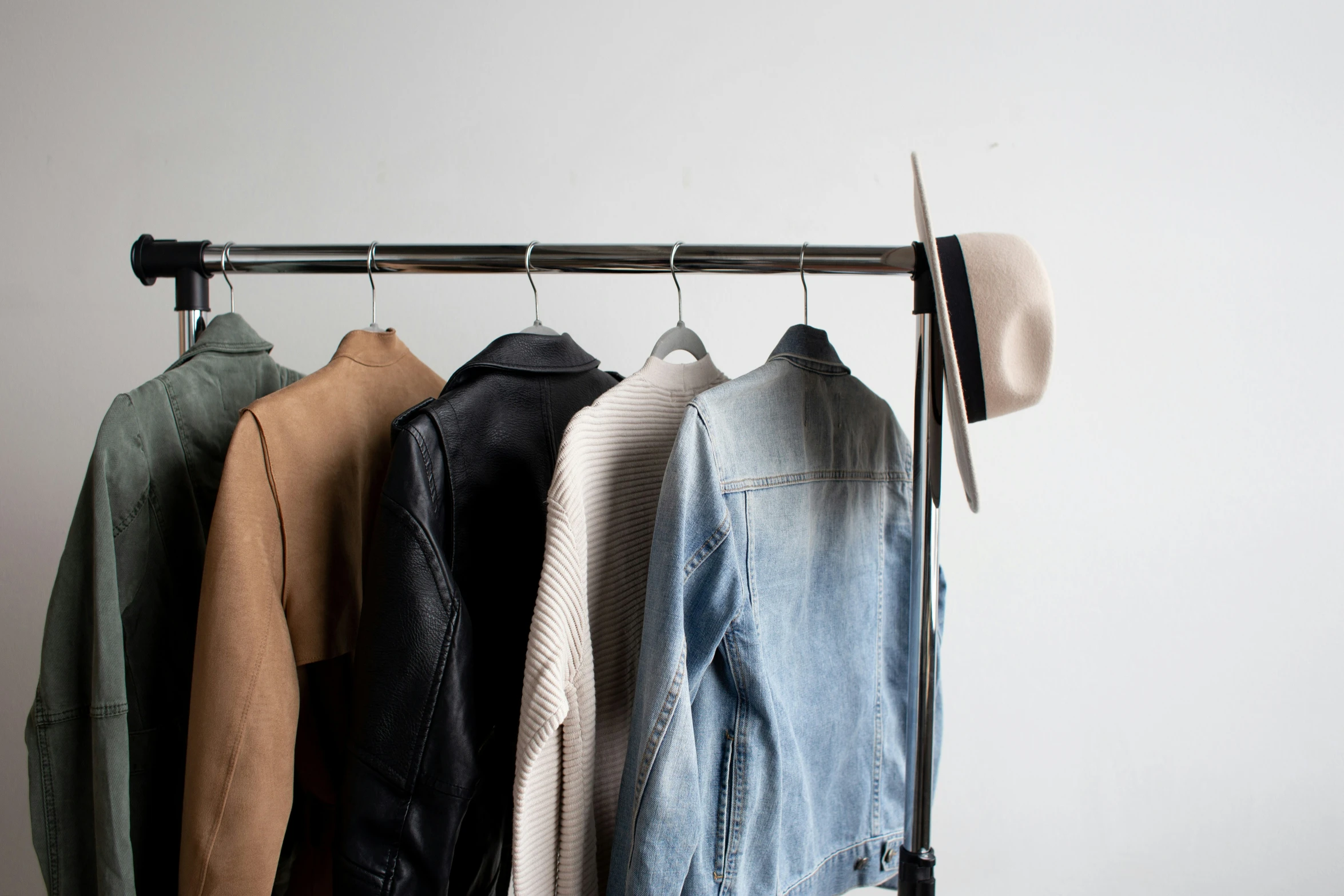 a rack full of clothes in the middle of the room