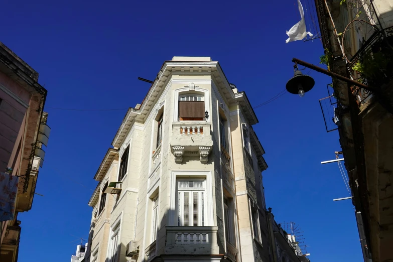 a tall building with an old fashion clock on it's side