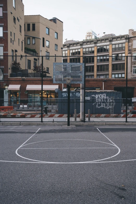 an outdoor basketball court that looks out over the town