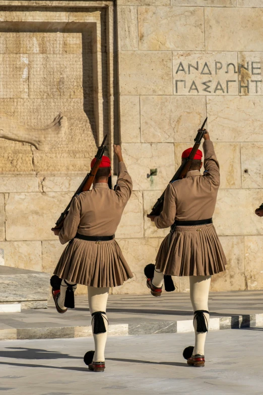 a line of people standing near a wall