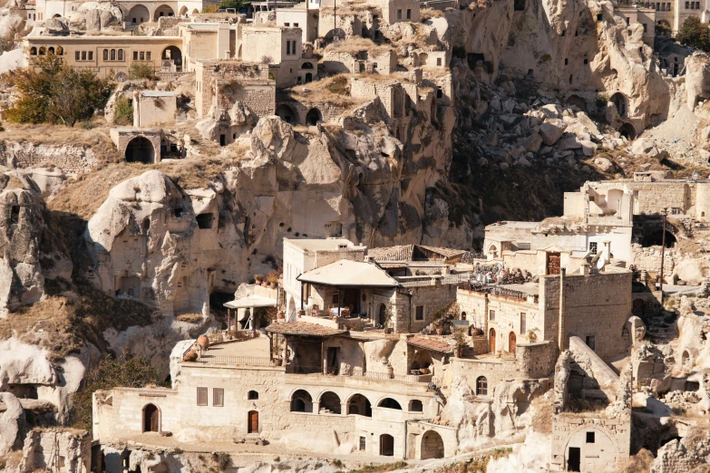 a large cliff side town made from many different rock formations