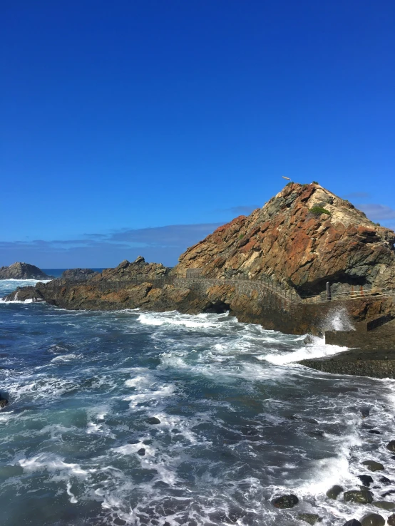 some very pretty rocks near the shore of some water