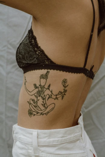a tattoo of flowers and a bell in lace