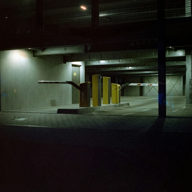 a dark parking garage with a few stalls