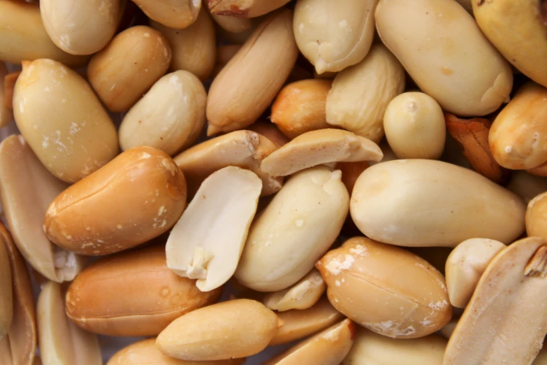 several nuts are being picked from this bin