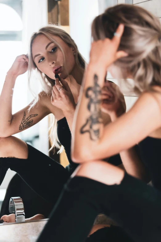 a woman sitting on the ground brushing her teeth