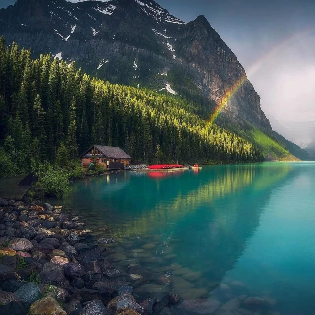 a body of water with trees and mountain in the background