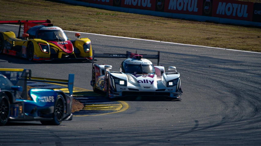 the race cars are running down the track