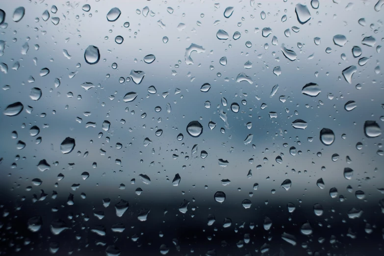 rain drops are seen on the glass of a window