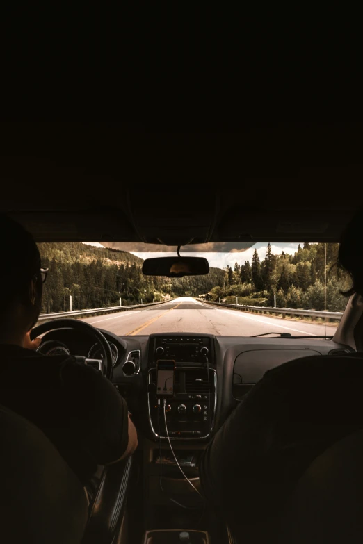 a car view inside a driving area with the sun going down