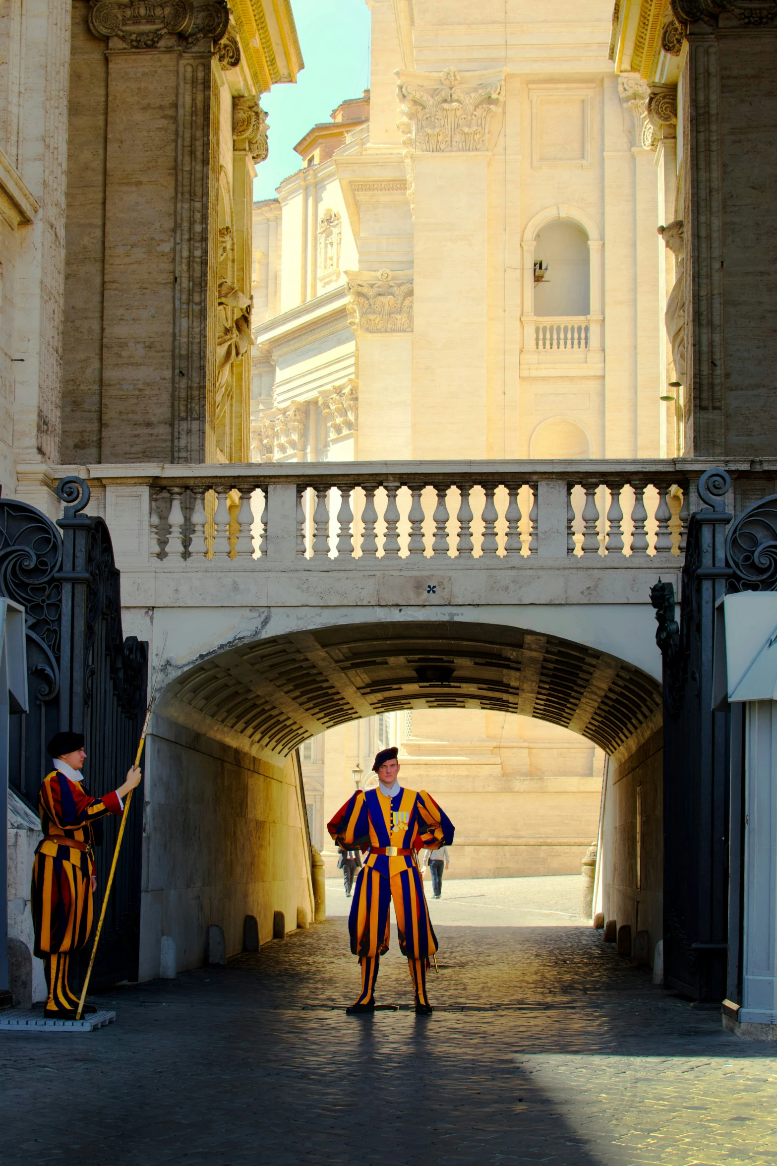 two men standing in front of a bridge wearing costume like clothing