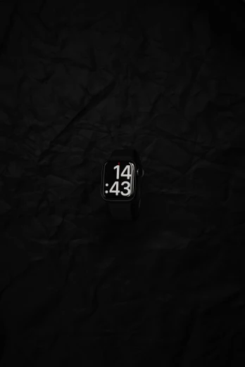 a small watch on a black background