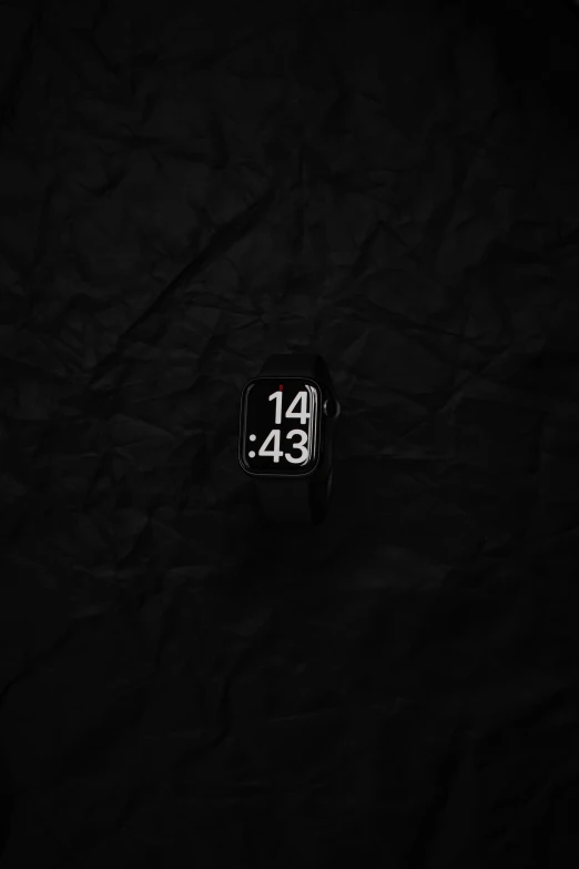 a small watch on a black background