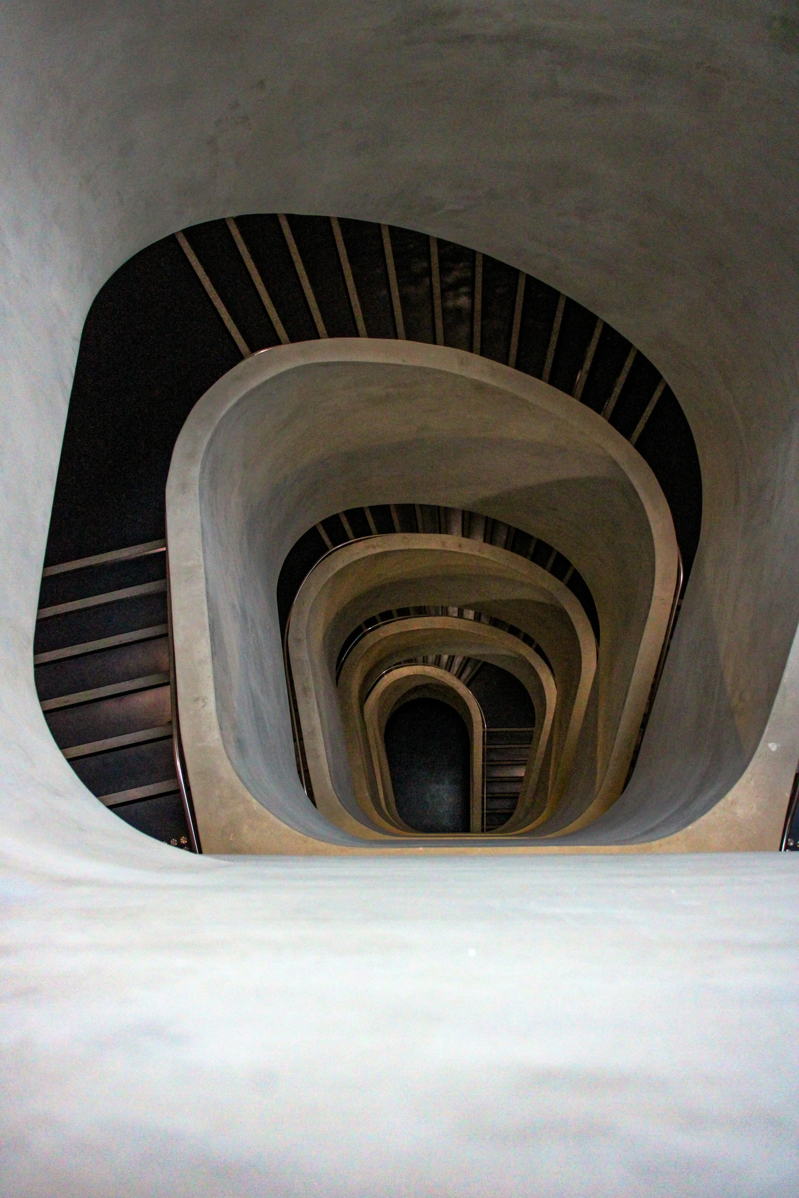 many curved stairs with skylights going into and out of them