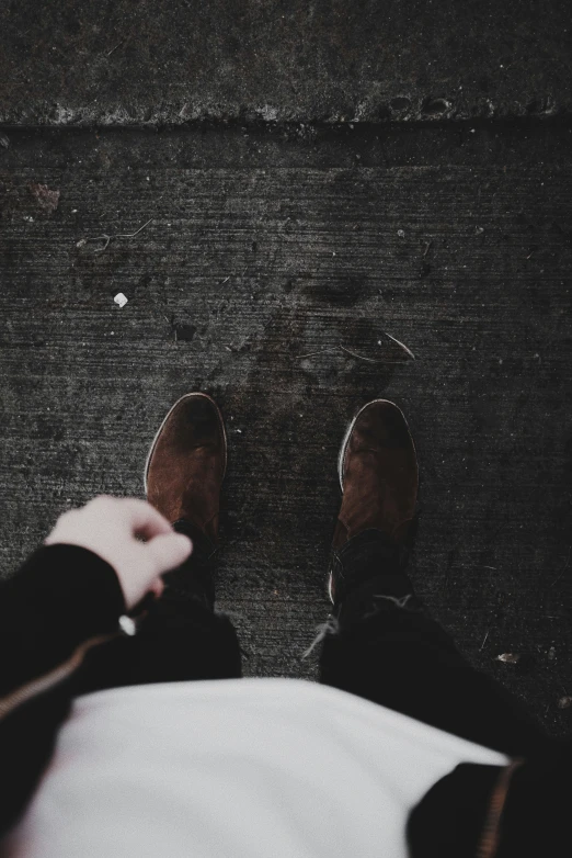 a pair of people standing next to each other with their feet up