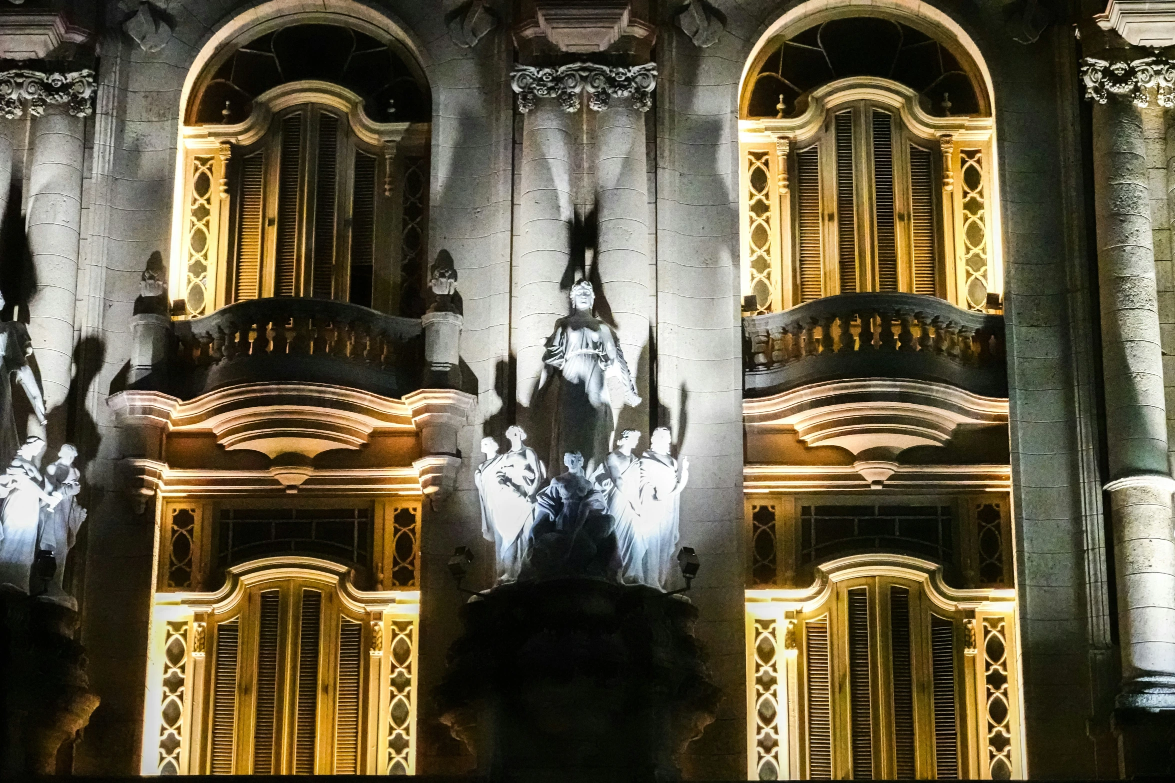 an image of the back of a building with windows lit up