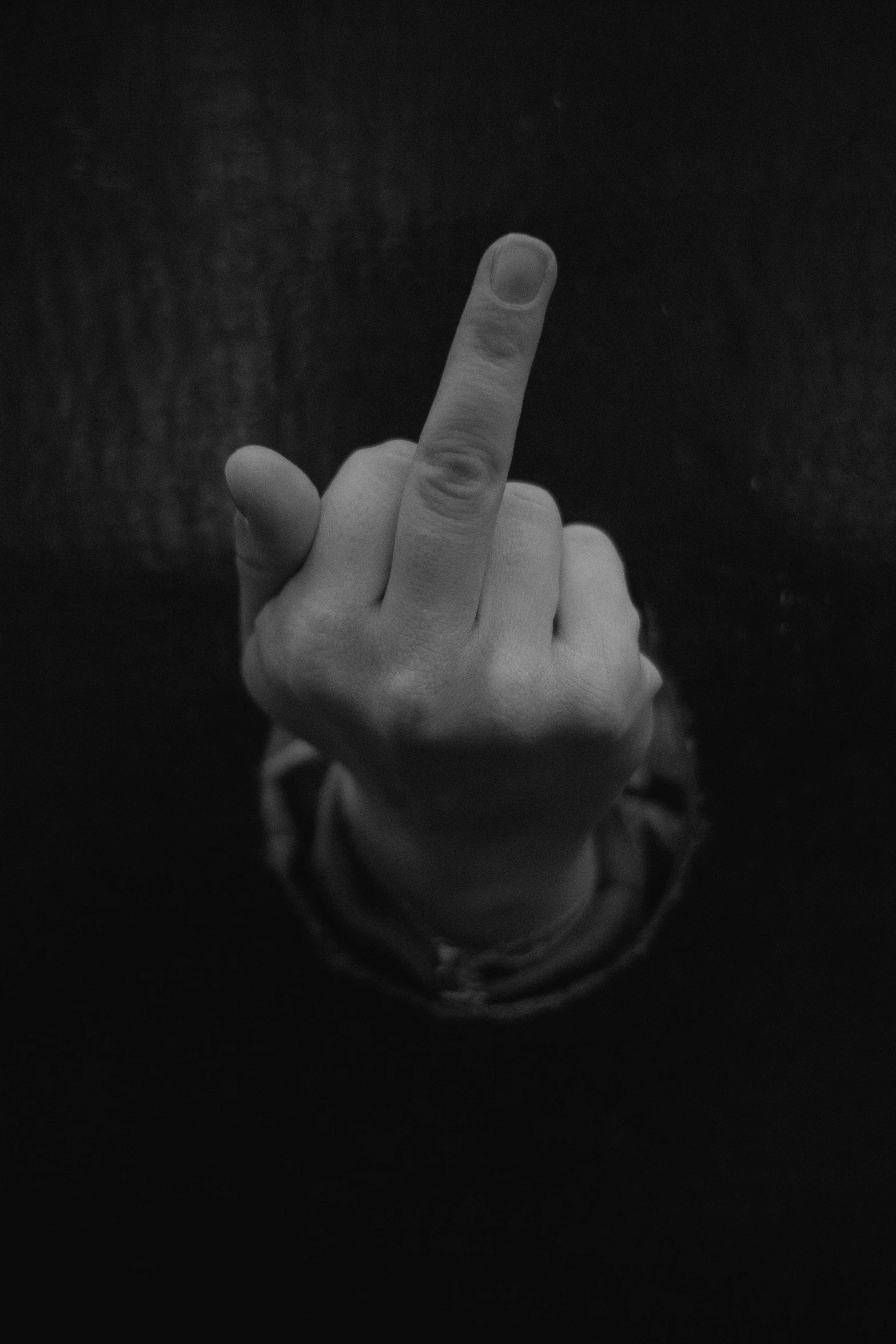 a person points his finger while holding a plate with the word pizza on it