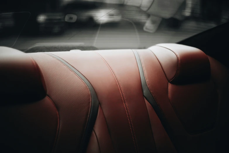 a close up of a leather seat with a red line on the seat