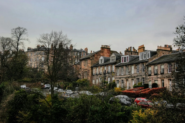 several buildings surrounded by wooded terrain on a cloudy day