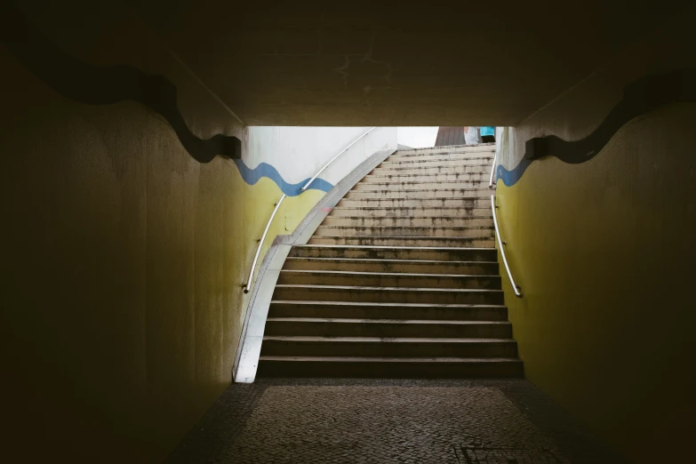 a set of stairs going up to a sky light