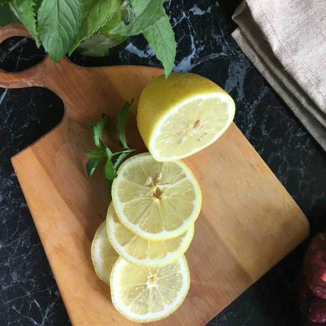 a  board with lemons and leaves on it