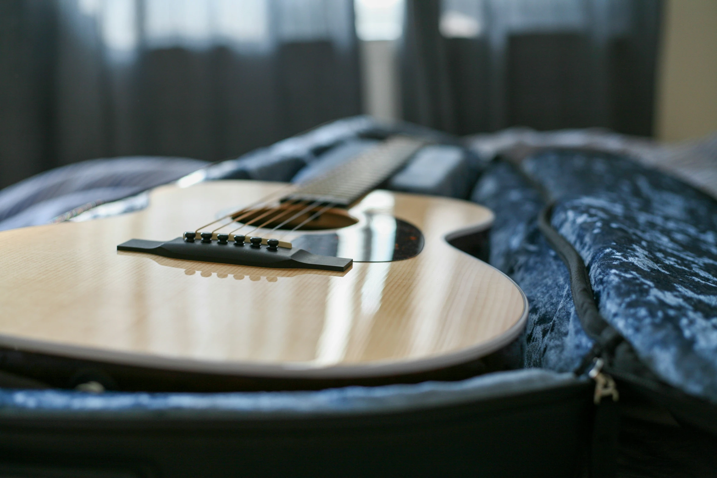 the guitar has been placed on the bed