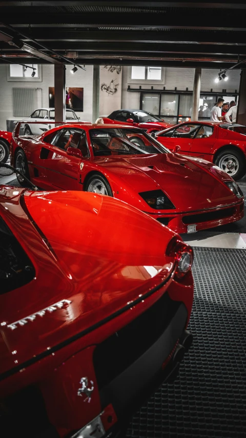 many red sports cars in a parking garage