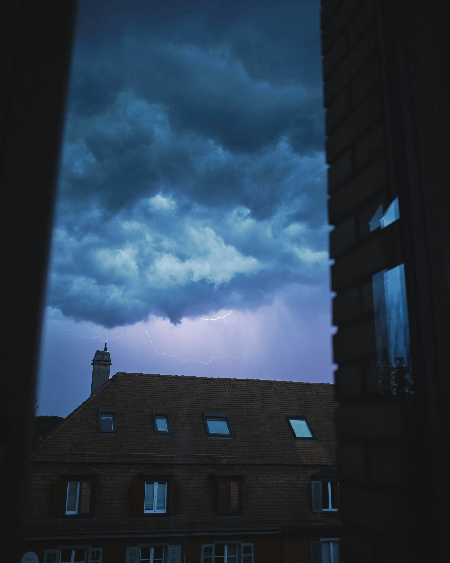 a city storm rolls through the sky over buildings