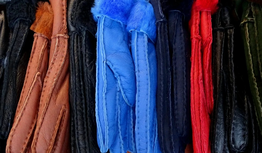 leather coats hang together in rows in a store