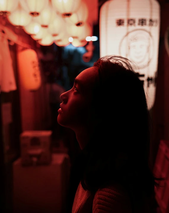 a dark woman is looking at the ceiling