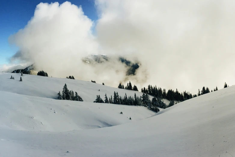 some clouds moving in to the mountain, some of which have burned