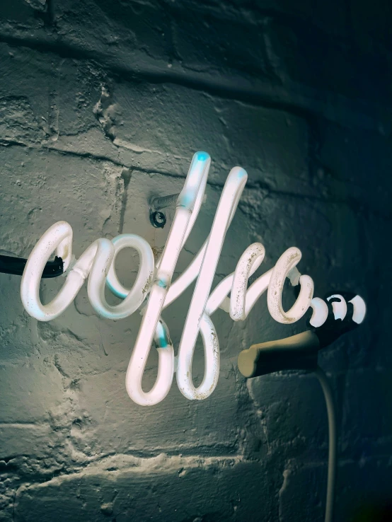 a coffee sign is lit up on a wall