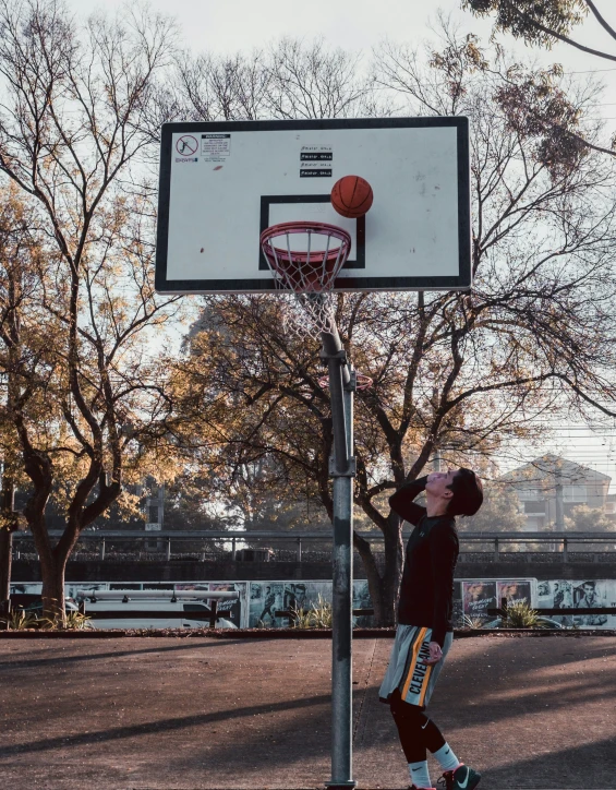 a man playing basketball on a basketball hoop