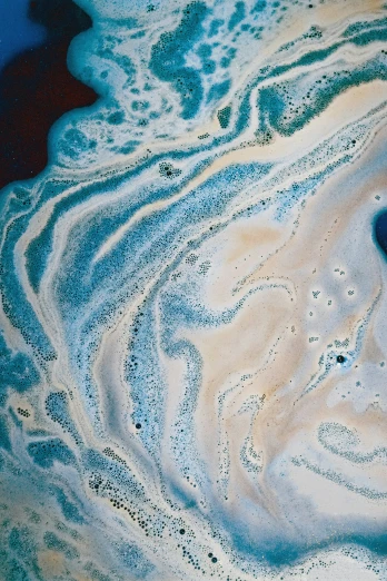 the image of blue paint in water and sand