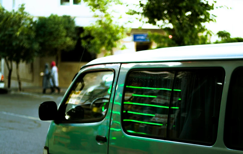 a car with green and black stripes on the side window