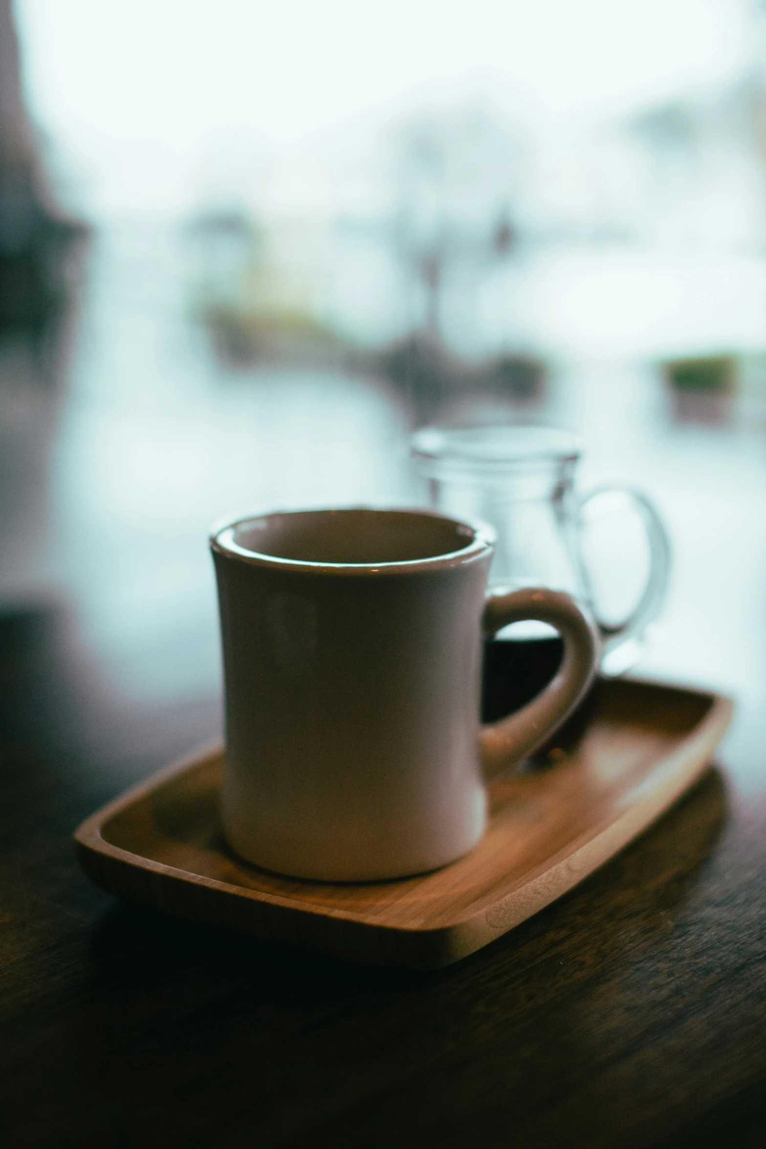 a white coffee mug on a wooden tray