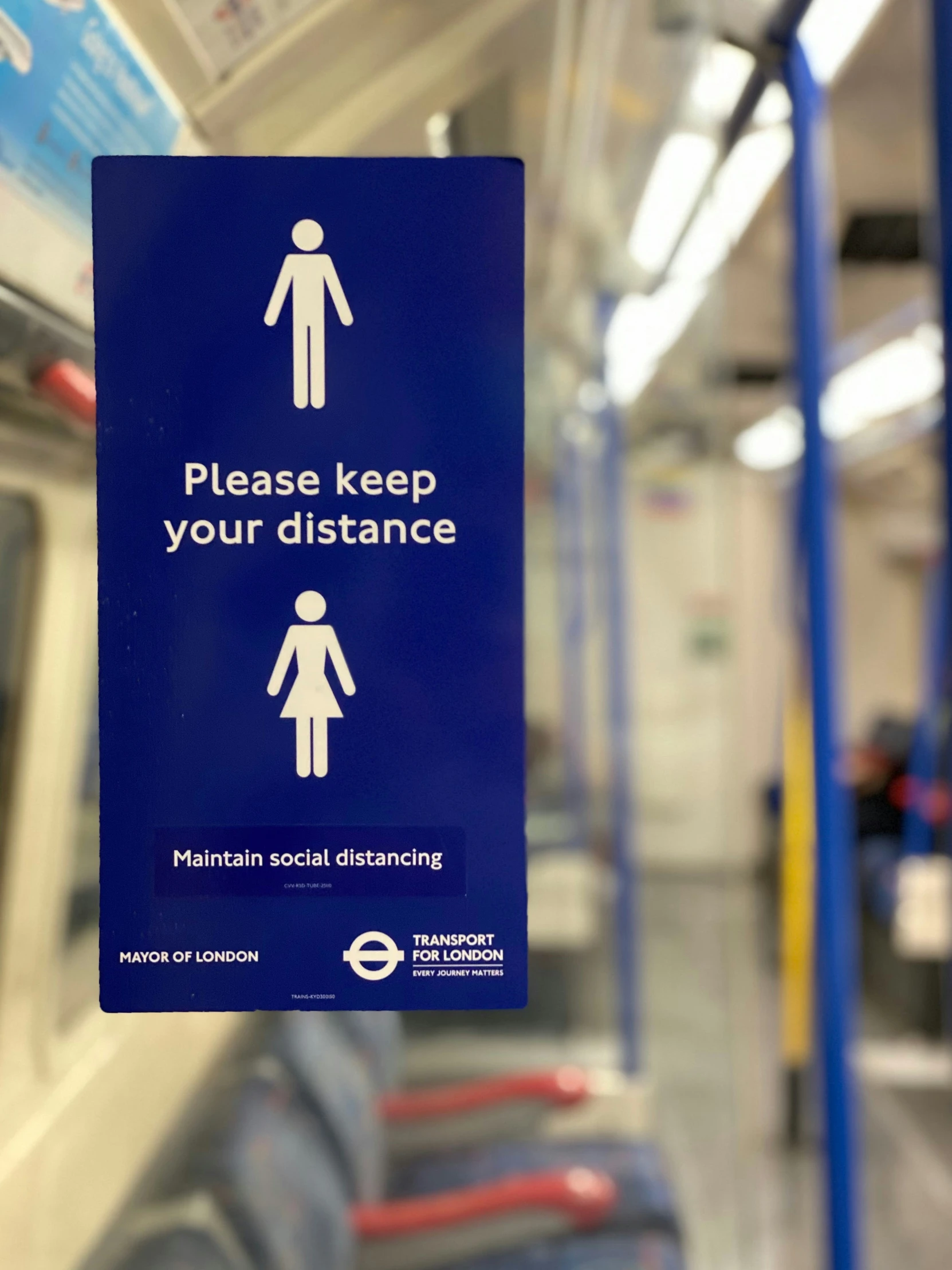 a sign hanging from a rail of a train