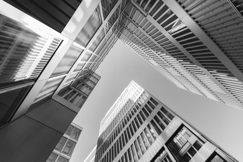 two tall buildings and a car park under a cloudy sky