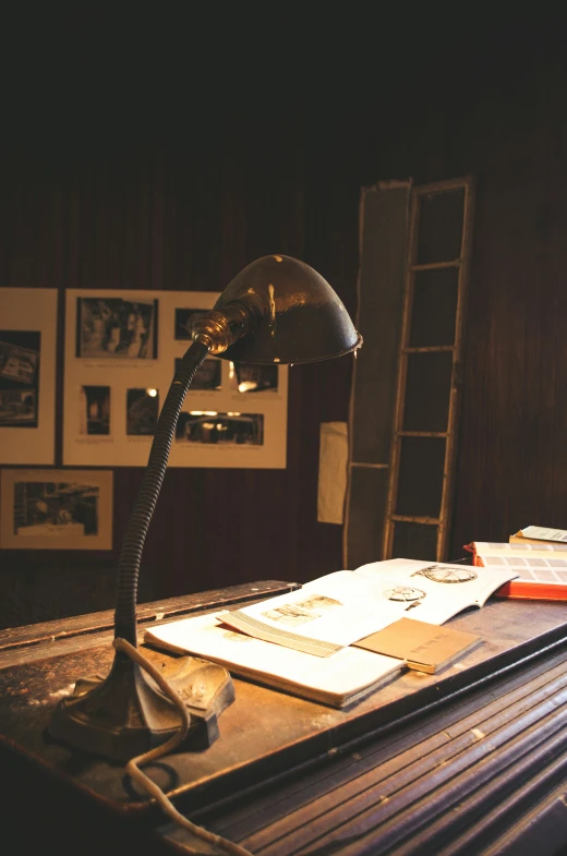 a lamp and some books on a wooden desk