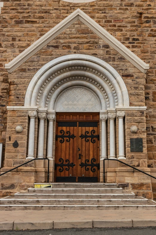 a stone cathedral with a large wooden doorway