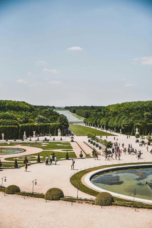 people walking around in a city with large trees